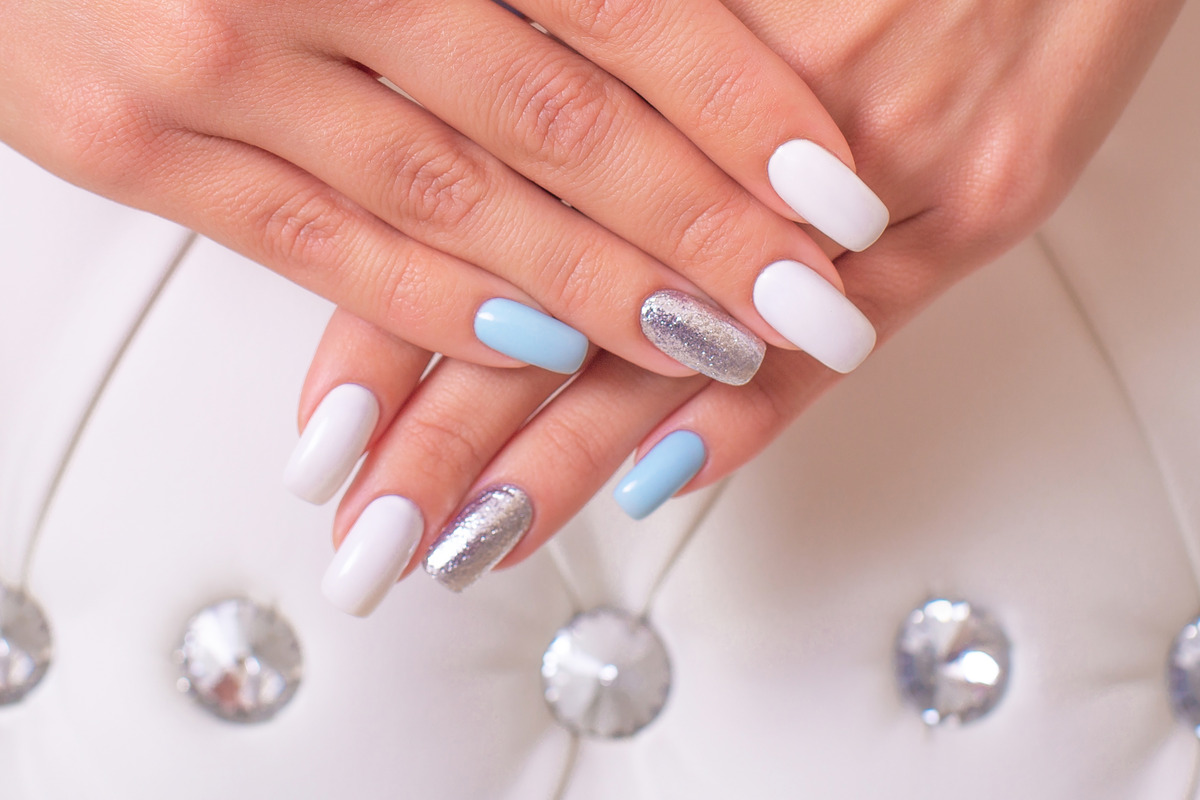 beautiful-female-hands-with-luxury-manicure-nails-blue-white-gel-polish